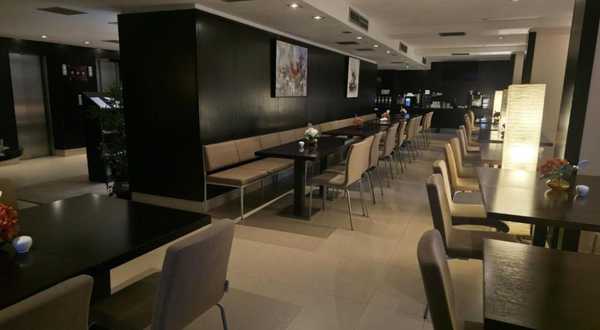 Breakfast room with banquette seating and buffet counter at CH Bucharest